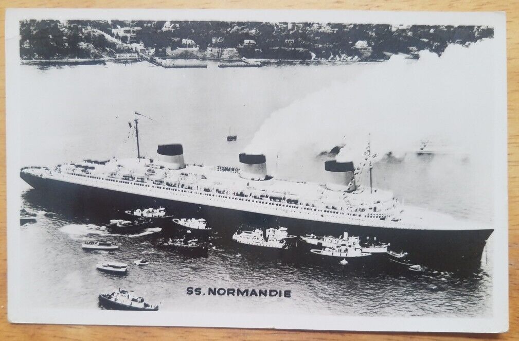 NORMANDIE (French) Aerial starboard view with many boats around it - c1937