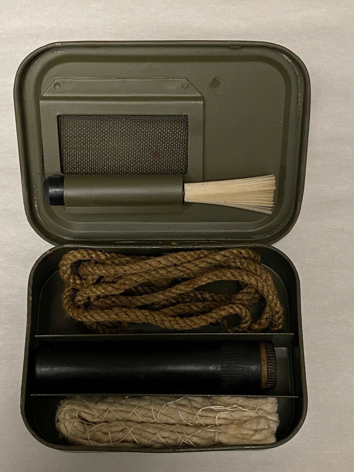 BRITISH ENFIELD RIFLE CLEANING KIT IN METAL TIN.